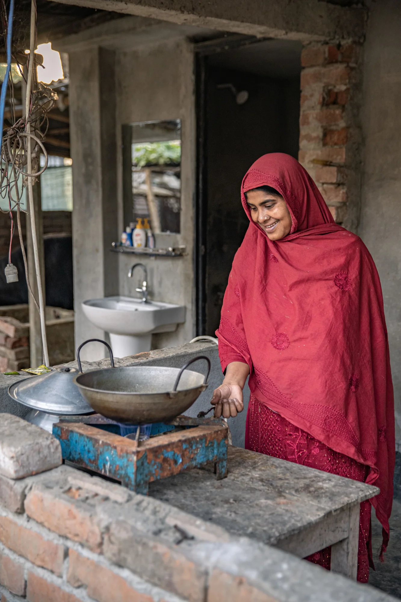 A woman cooking on a biogas stove in Bangladesh, photographed for Heifer International