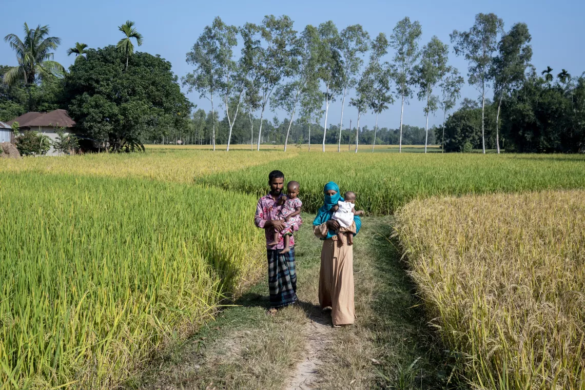 Family walking through agricultural fields in northwest Bangladesh