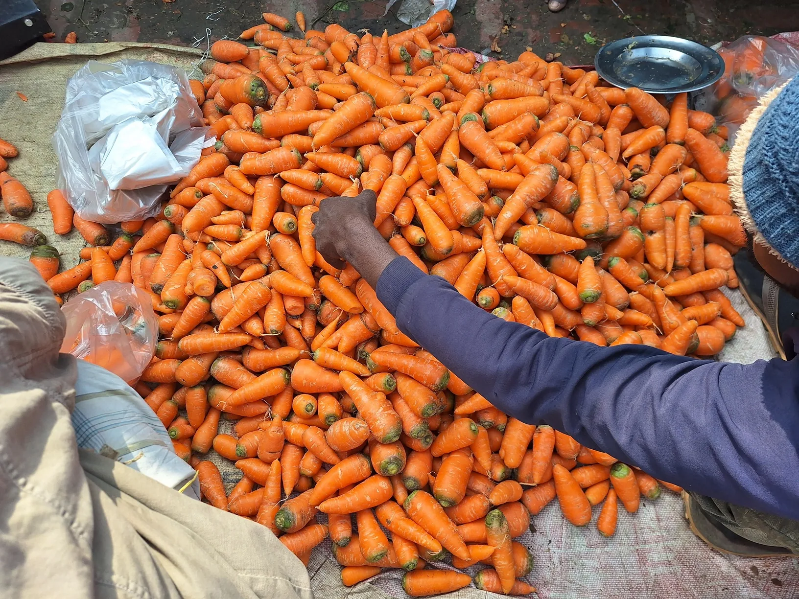 Workers handle bagged produce during aggregation and loading in Bangladesh.