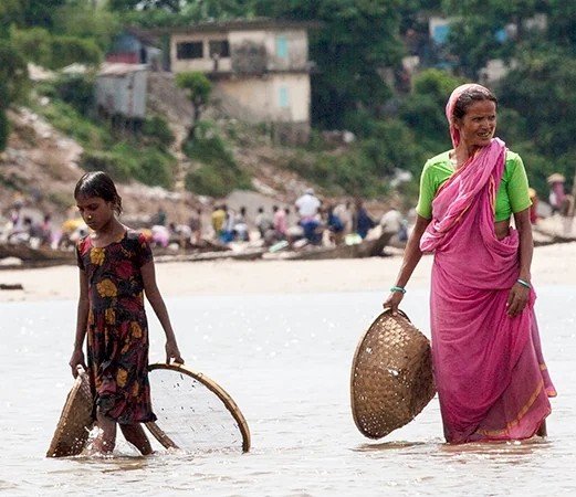 A woman moving through floodwater in Bangladesh