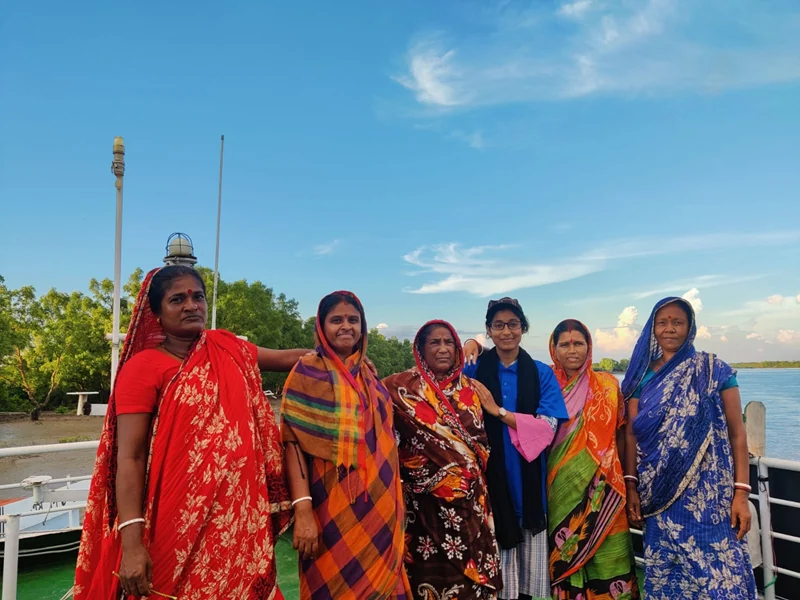 Women travelling through a southwest Bangladesh river landscape